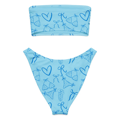 Woman wearing the Vibewear 'Blue Crush' bandeau bikini set, which features a vibrant blue abstract pattern, a strapless top, and flattering high-leg bottoms.