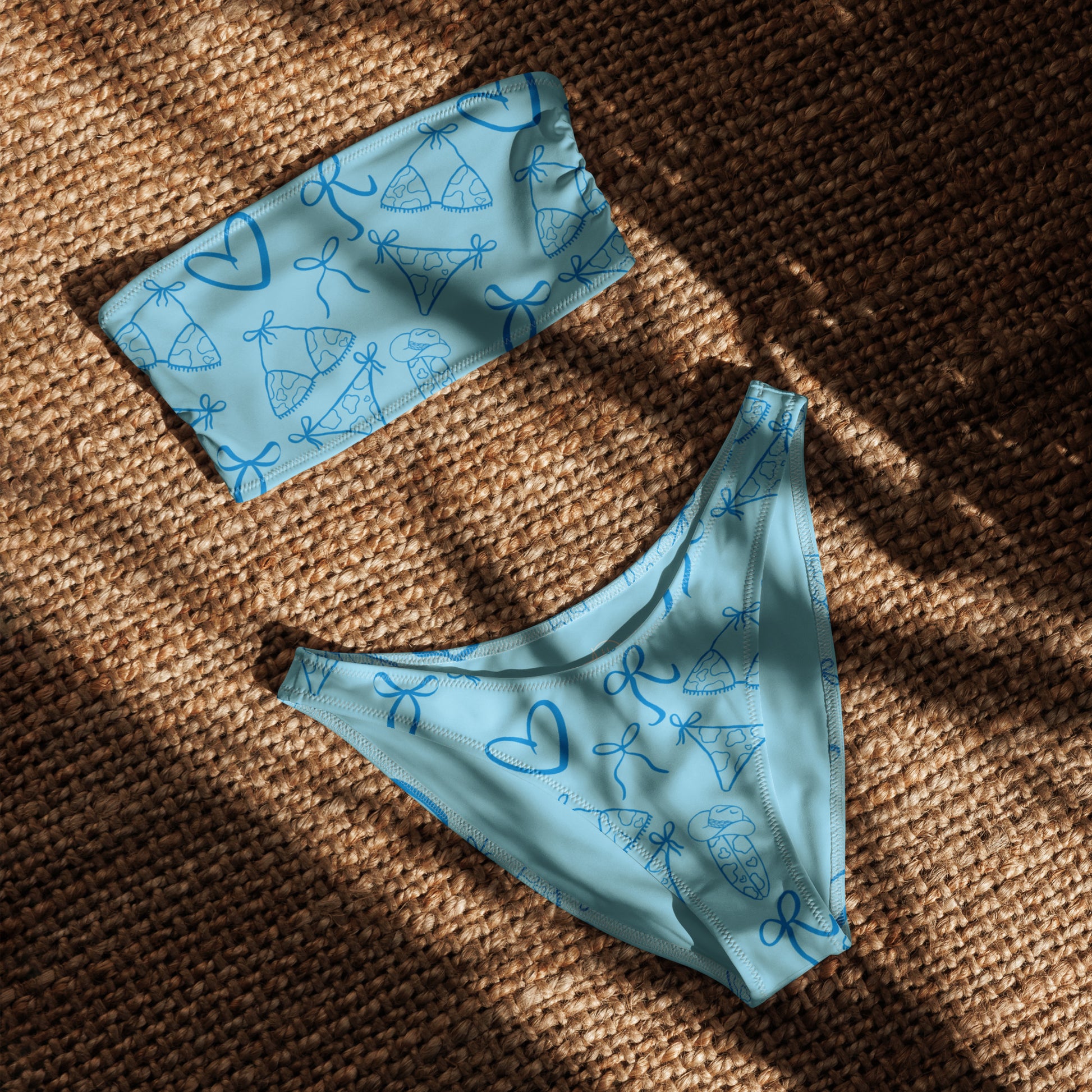 Woman wearing the Vibewear 'Blue Crush' bandeau bikini set, which features a vibrant blue abstract pattern, a strapless top, and flattering high-leg bottoms.