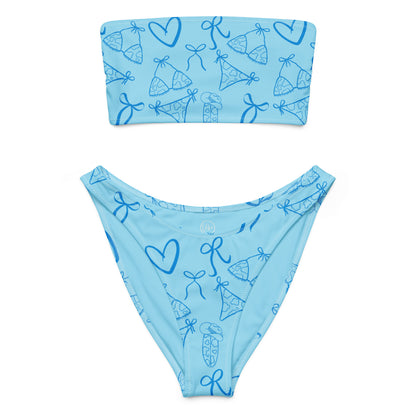 Woman wearing the Vibewear 'Blue Crush' bandeau bikini set, which features a vibrant blue abstract pattern, a strapless top, and flattering high-leg bottoms.