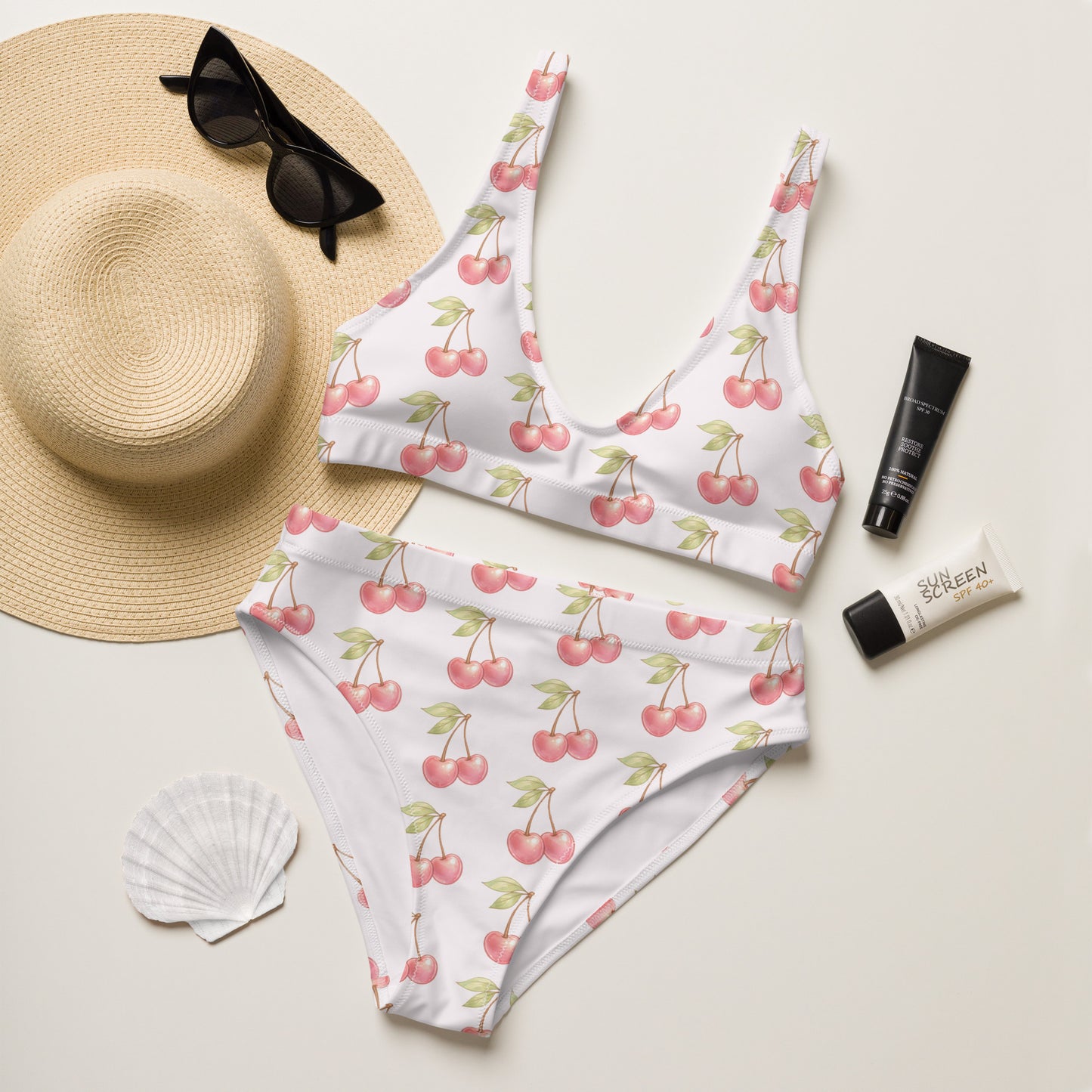 Cherry Sweet recycled high waisted bikini laid flat with summer accessories