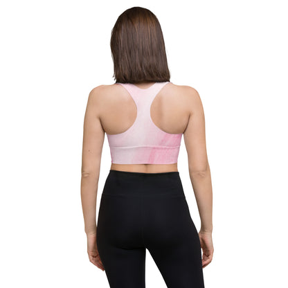 Back view of model wearing Motivated recycled longline sports bra with racerback design