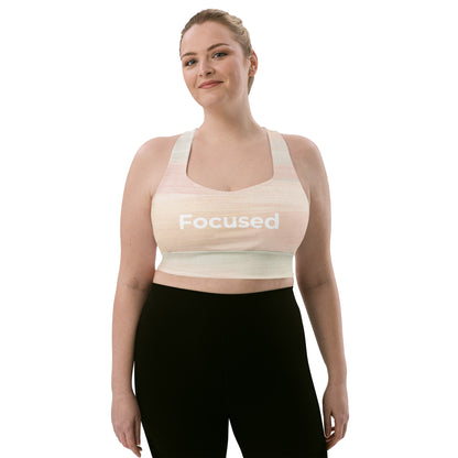 Model wearing Focused recycled longline sports bra in neutral tone front view