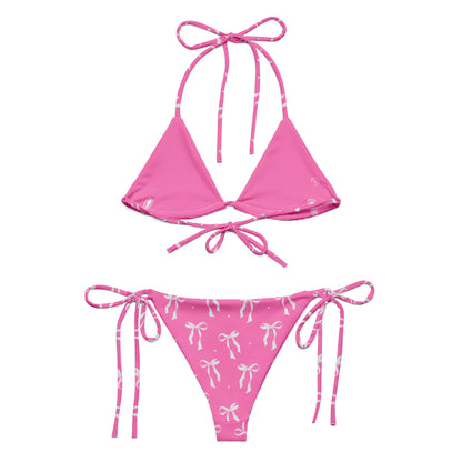 VibeWear Eco friendly pink bikini with bow pattern laid flat