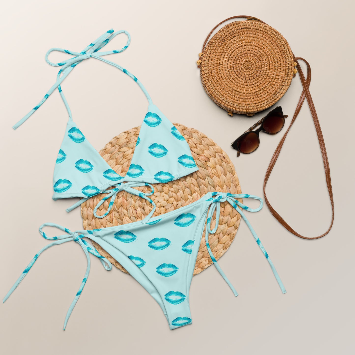 Ocean Kiss recycled string bikini set laid flat with blue ocean inspired print