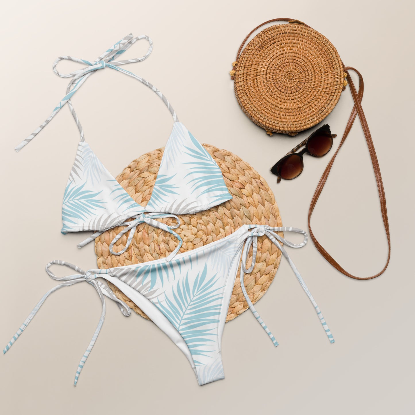 Palm Breeze recycled string bikini laid flat with summer accessories