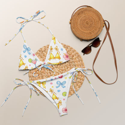 Summer Spritz recycled string bikini set laid flat with summer accessories