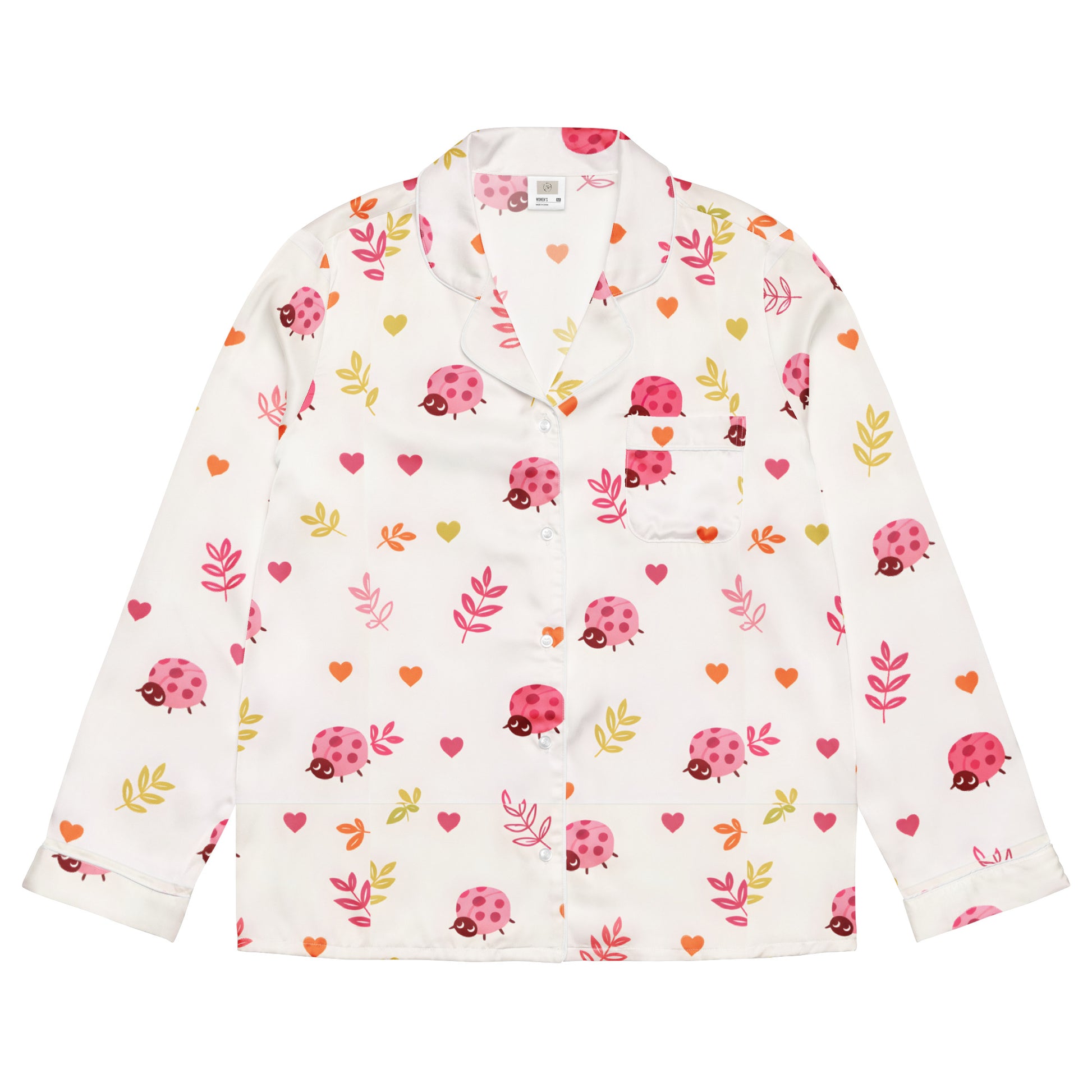 Woman wearing the Vibewear 'Ladybird Daydream' long sleeve satin pajama top, showing the cute red ladybug pattern and classic button-front style.