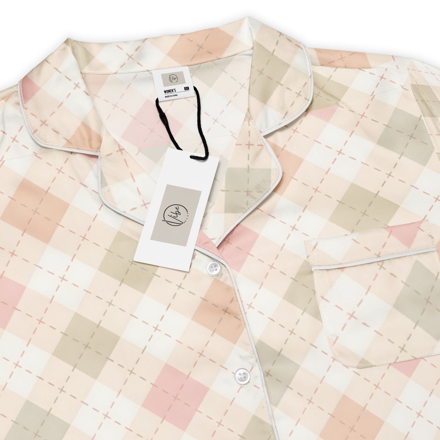 Woman wearing the 'Blush Cottage Argyle' long sleeve satin pajama top, showing the pink argyle pattern and classic button-front style.