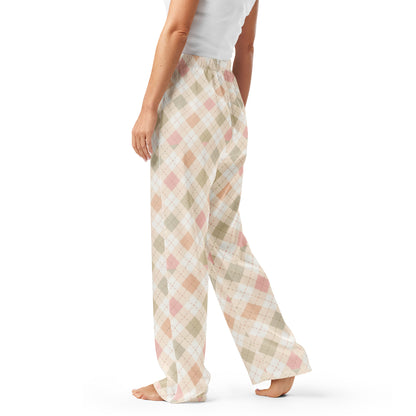 Woman wearing the Vibewear 'Blush Cottage Argyle' satin pajama pants, highlighting the pink argyle pattern and the relaxed, straight-leg fit.