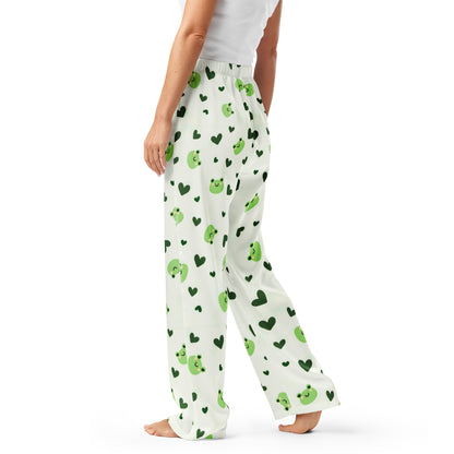 Woman wearing the 'Lily Love' satin pajama pants, highlighting the cute green frog and heart pattern.