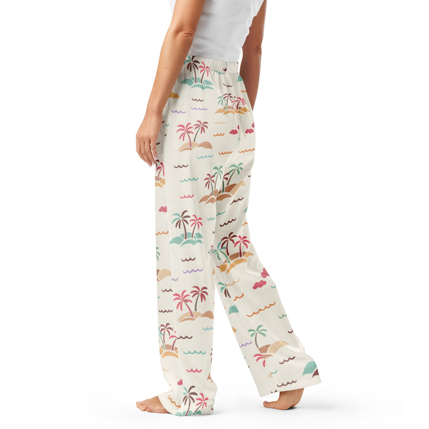 Woman wearing the Vibewear 'Sorbet Shores' satin pajama pants, highlighting the colourful abstract pattern and relaxed straight-leg fit.