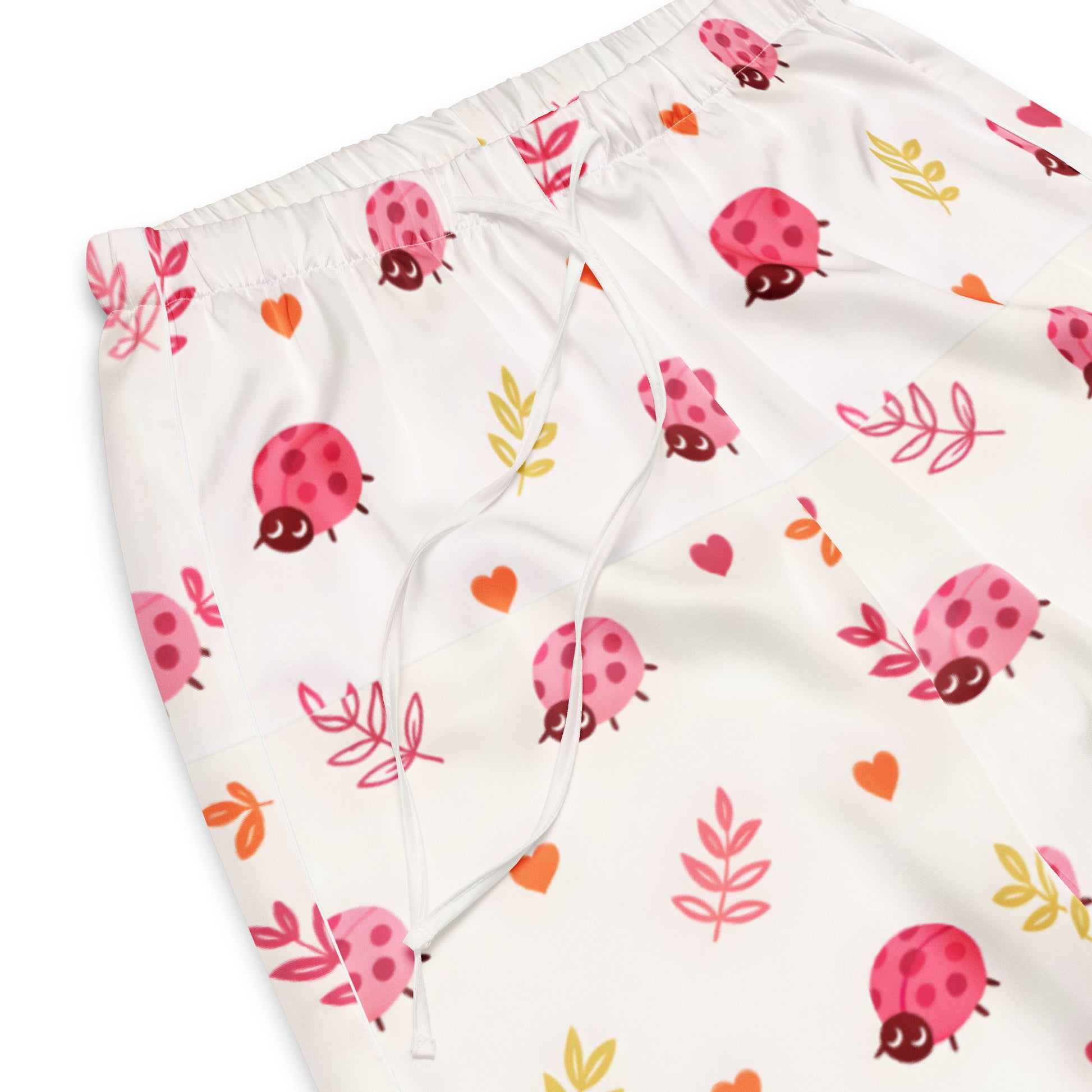 Vibewear 'Ladybird Daydream' satin pajama pants, highlighting the cute red ladybug pattern and the relaxed, straight-leg fit.