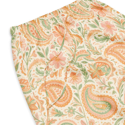 Vibewear 'Vintage Palm' satin pajama pants, highlighting the green and orange tropical leaf pattern and the relaxed, straight-leg fit.