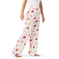 Woman wearing the Vibewear 'Ladybird Daydream' satin pajama pants, highlighting the cute red ladybug pattern and the relaxed, straight-leg fit.