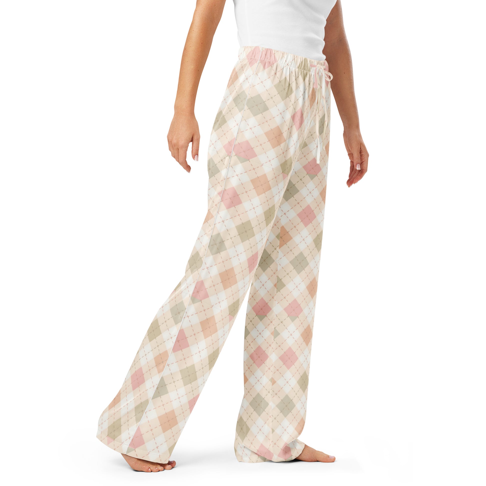 Woman wearing the Vibewear 'Blush Cottage Argyle' satin pajama pants, highlighting the pink argyle pattern and the relaxed, straight-leg fit.