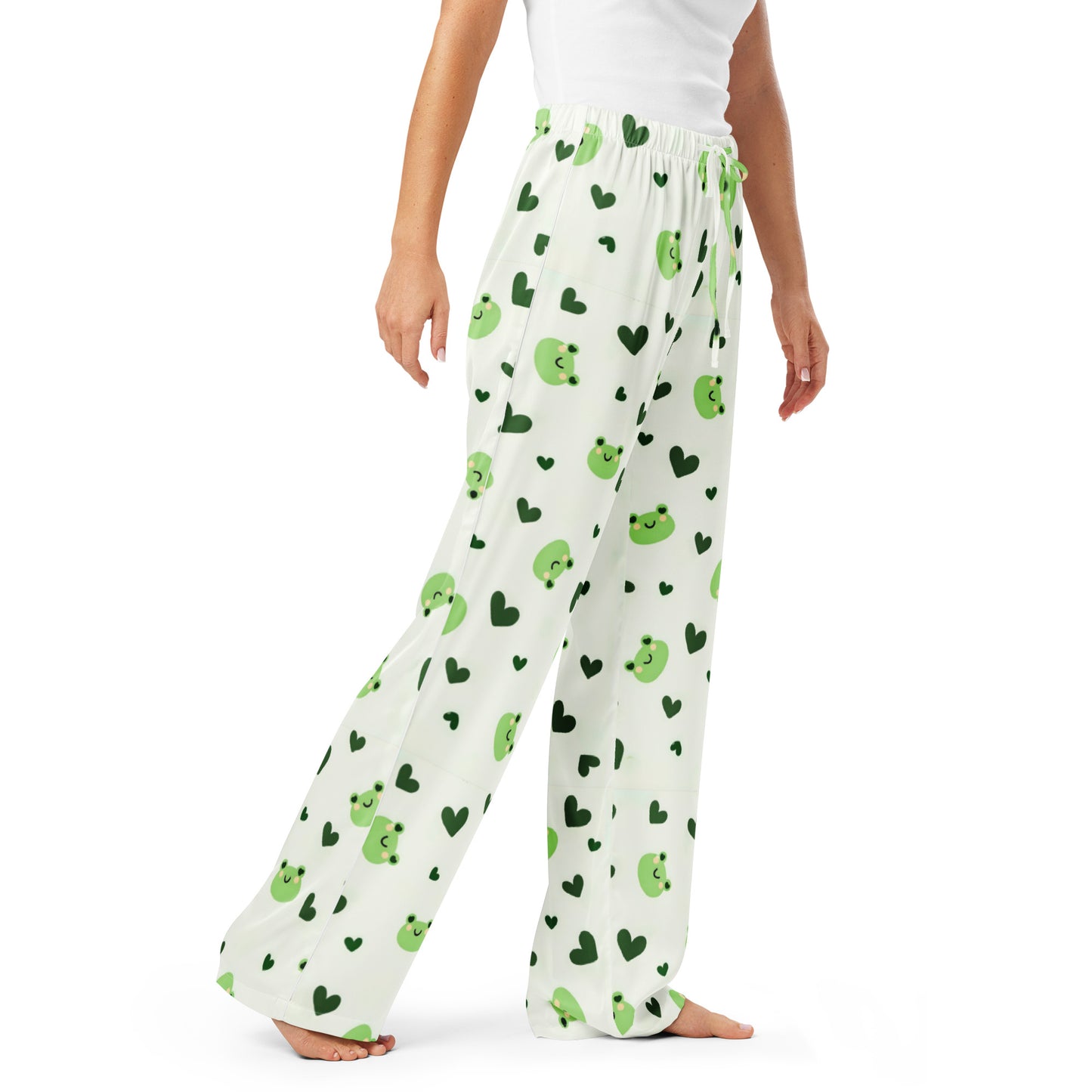 Woman wearing the 'Lily Love' satin pajama pants, highlighting the cute green frog and heart pattern.