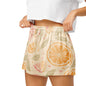 Close up of model wearing Citrus Glow womens pajama shorts showing elastic waistband and citrus print