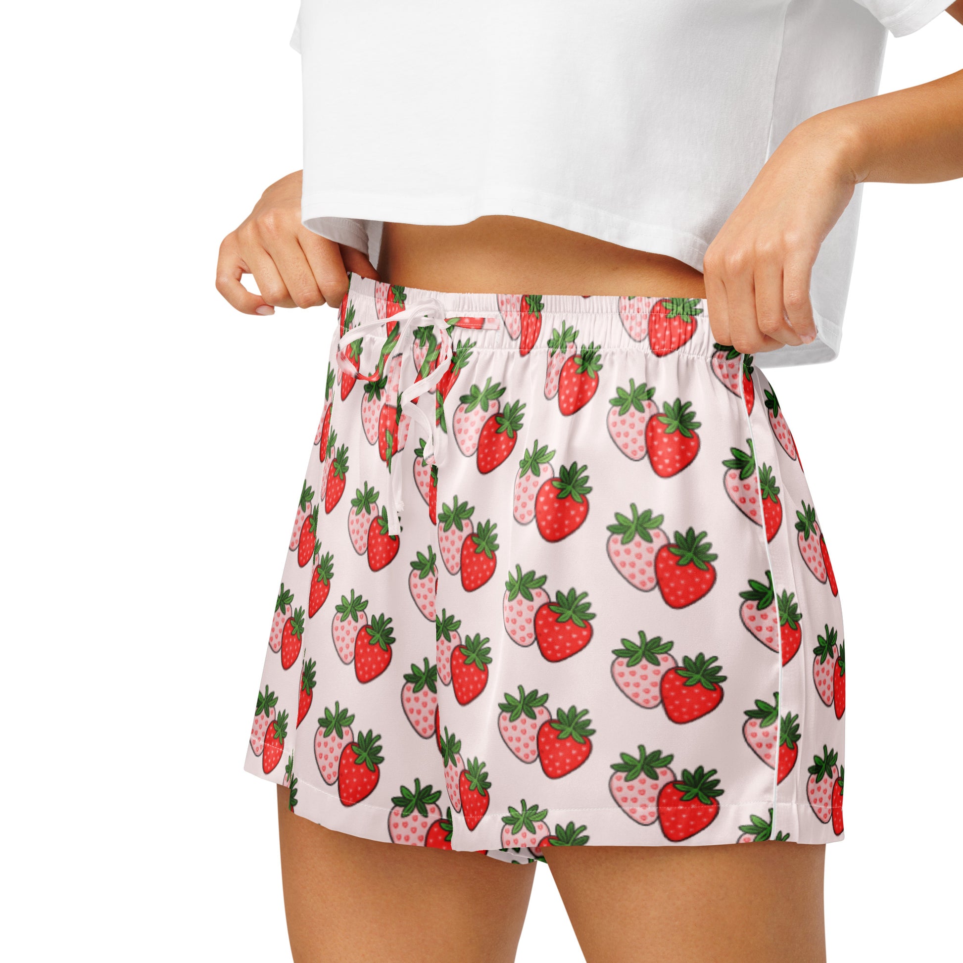 Close up of model wearing Berry Blush Bliss womens pajama shorts showing elastic waistband and strawberry print