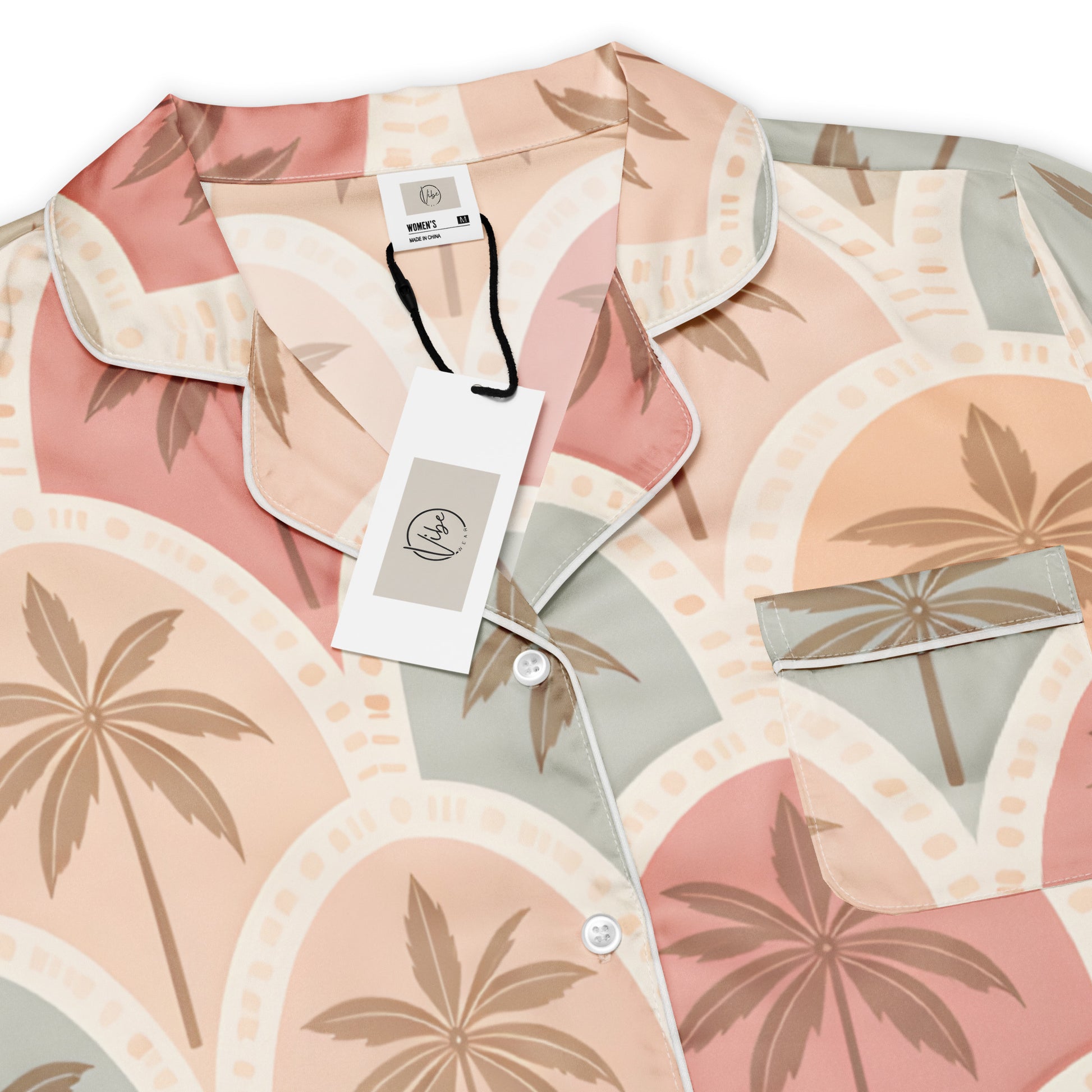 Front view of the Vibewear 'Sunset Palm Mosaic' women's satin pajama top with its intricate blue and orange pattern.