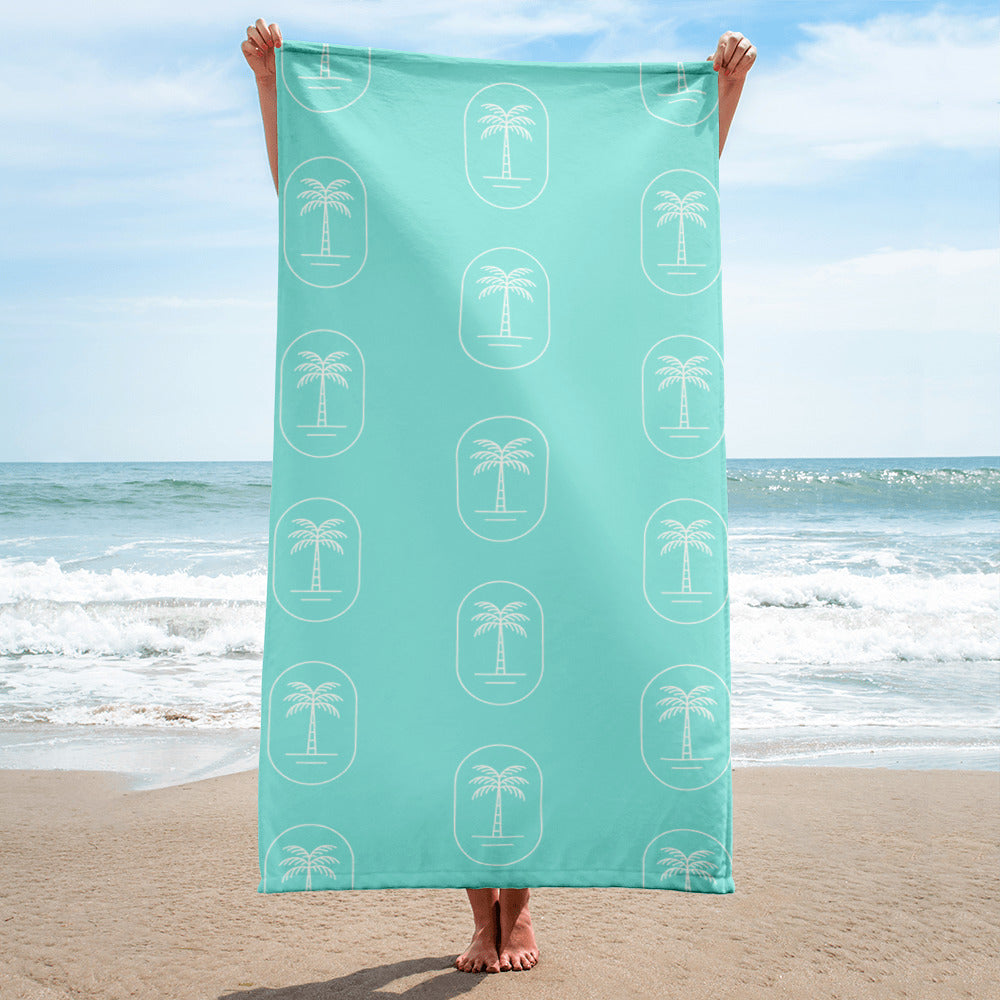 The 'Aqua Palms' towel, displaying the vibrant aqua-blue palm tree pattern