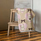 Frenchie Love bath or beach towel with French Bulldog print hanging indoors