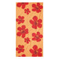Red floral bath and beach towel with warm sunset background