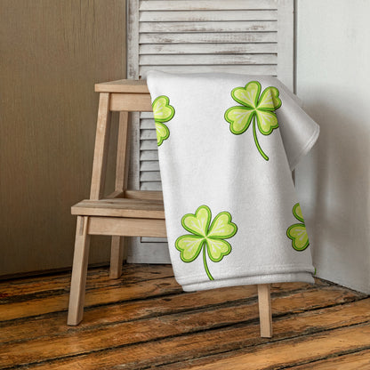 Lucky Clover bath or beach towel with four leaf clover print draped over chair