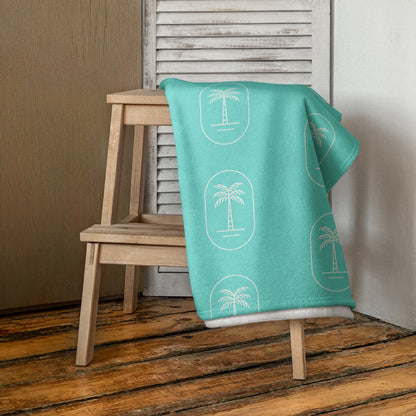 The 'Aqua Palms' towel, displaying the vibrant aqua-blue palm tree pattern