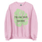 The 'Follow Your Dreams' classic sweatshirt shown in light pink, with the motivational slogan printed in a white script and sans-serif font across the chest.