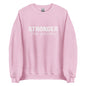 The 'Stronger Than Yesterday' classic sweatshirt shown in light pink, with the motivational slogan printed in a bold, white, distressed font across the chest.