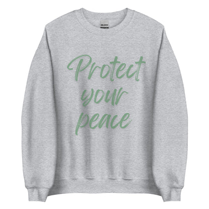 The 'Protect Your Peace' classic sweatshirt shown in light grey, with the slogan printed in a green retro-style font 